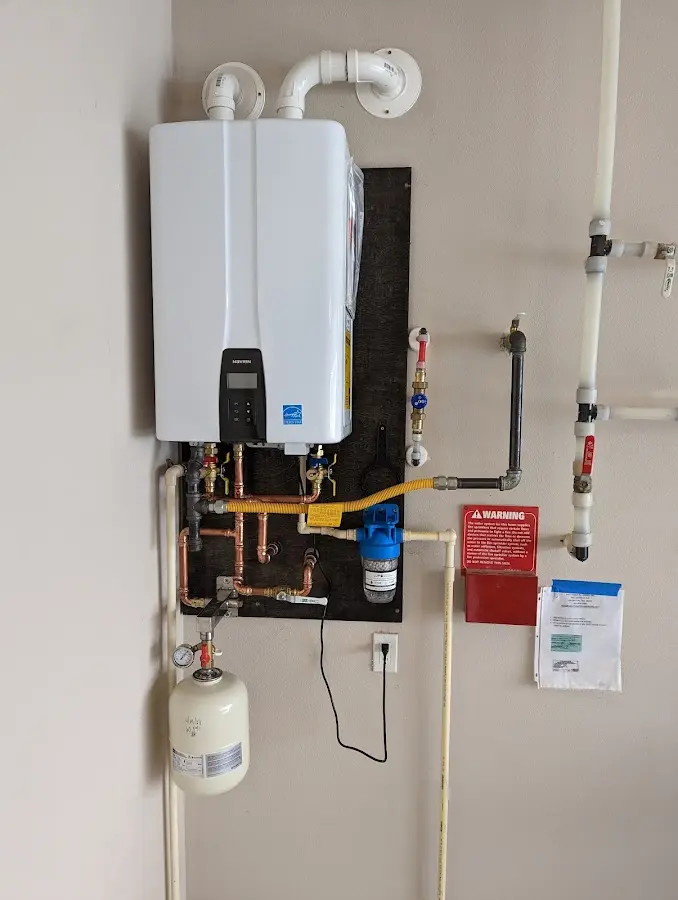 Professional plumber installing copper piping in a Waimanalo Beach home